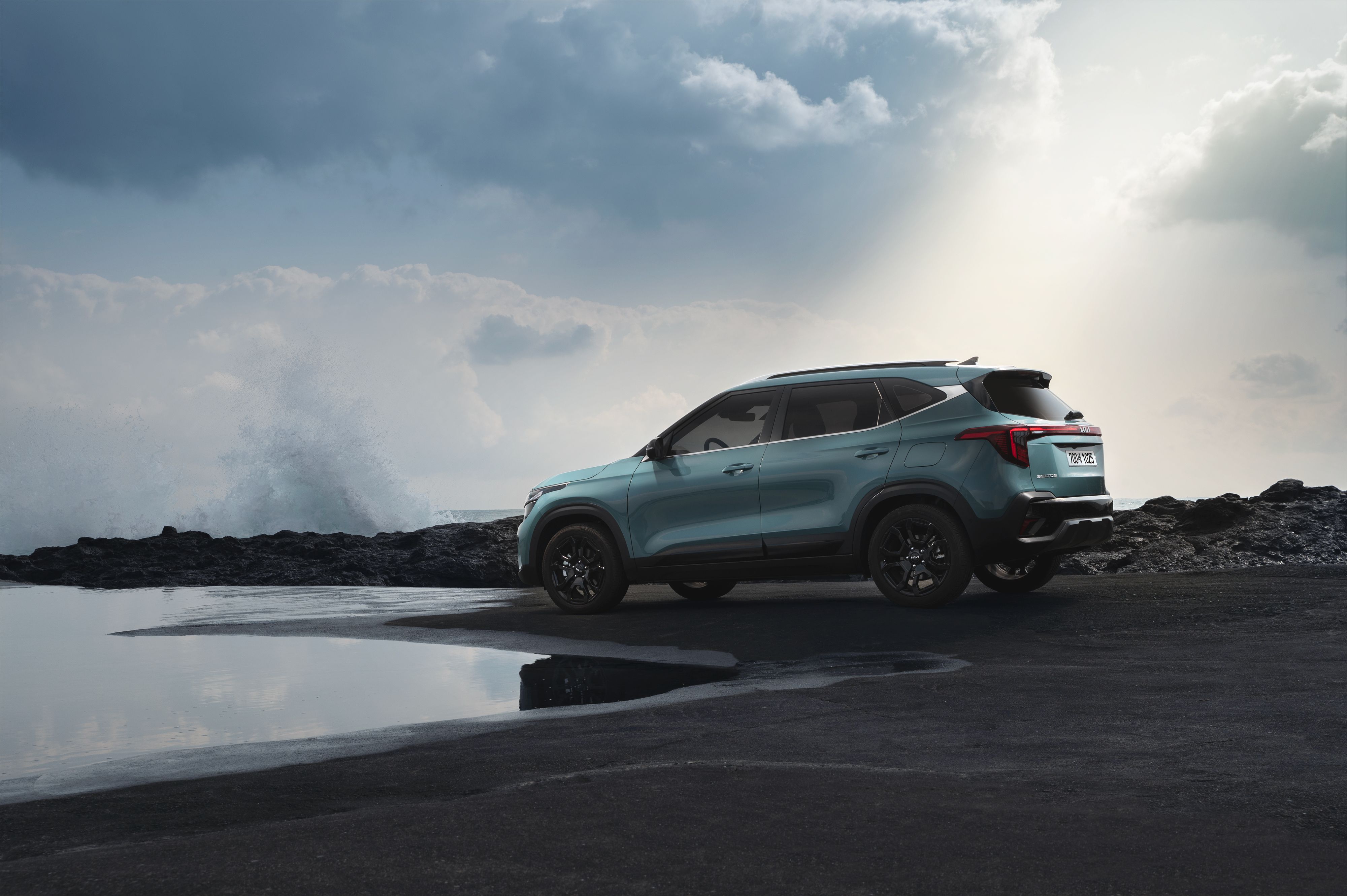  a New Suv on the shore of a lake