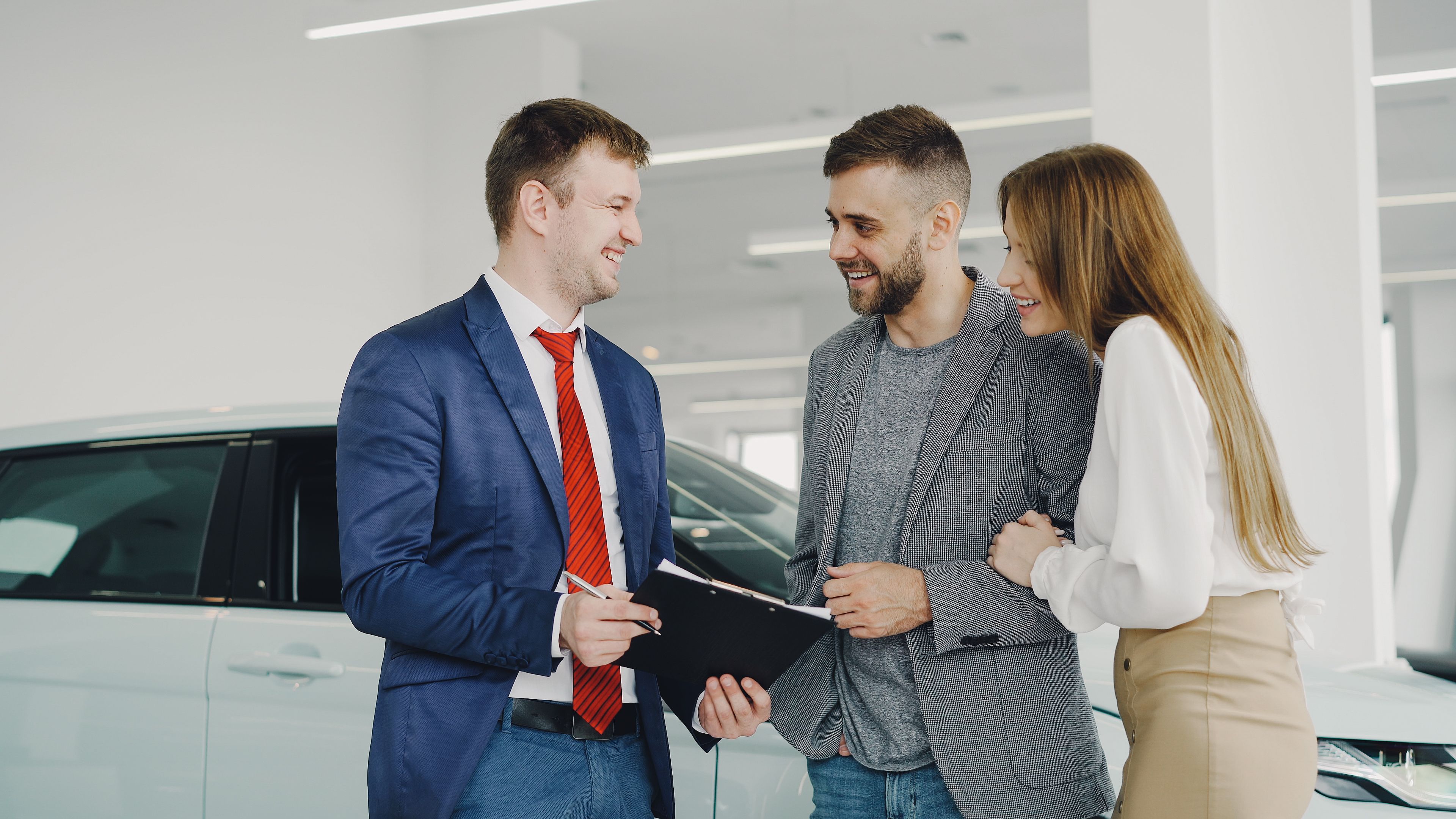 picture of a man signing a HP form at the car sales dealer
